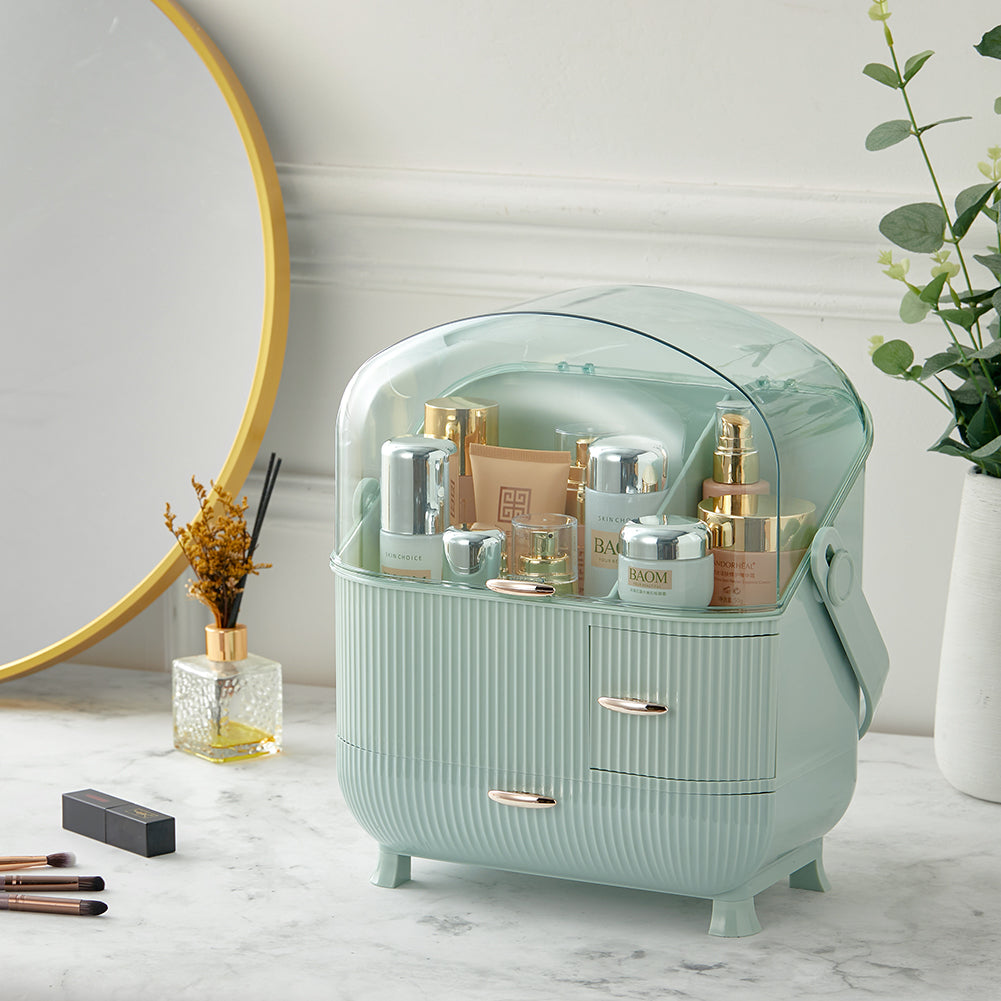 Mint green makeup organizer with clear dome, cosmetics bottles inside, ribbed drawers